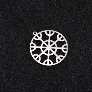 Close-up of a silver stainless steel snowflake pendant with intricate geometric cutouts