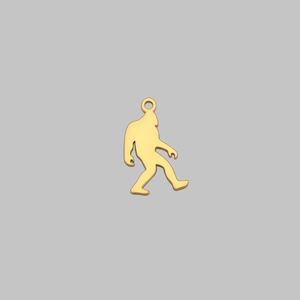 Detailed view of a polished golden Bigfoot metal pendant with an integrated top loop