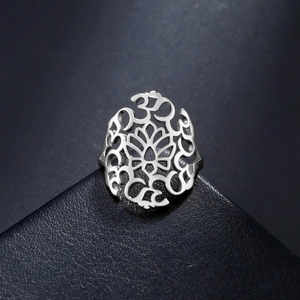 Polished silver titanium steel ring featuring a cutout lotus and Om symbols for yoga style