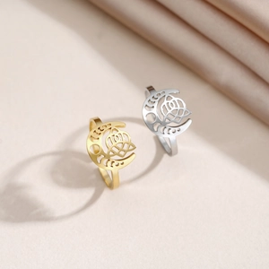 Detailed view of moon and rose hollow patterns on gold and silver stainless steel rings