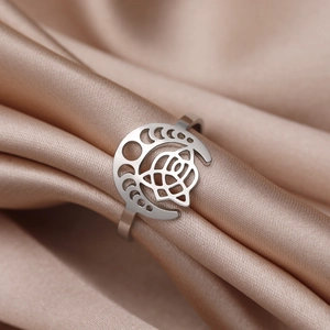 Vintage stainless steel celtic knot ring with moon and rose motif on silk background
