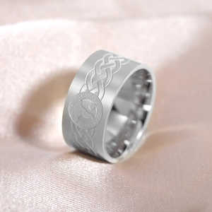 Macro detail of silver Celtic knot ring featuring a wolf howling at the moon relief
