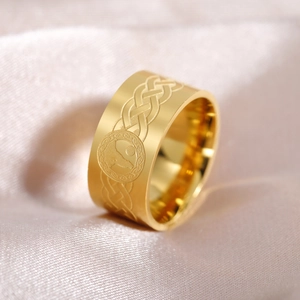 Gold stainless steel Celtic knot ring with wolf totem, 10mm wide band on satin background
