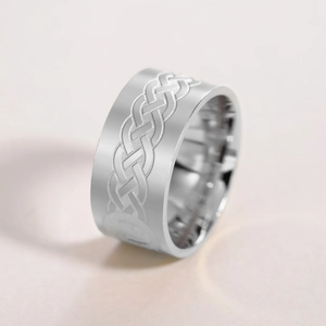 Macro shot of 10mm wide stainless steel ring with Celtic knot engraving and polished finish