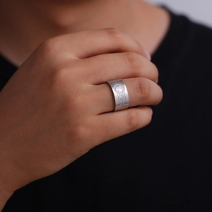 Detailed close-up of 10mm wide stainless steel ring with Celtic knot and moon engraving