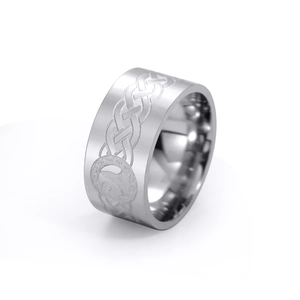 Macro view of wide steel ring with brushed finish, Celtic knot and wolf totem engravings