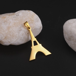 Polished gold Eiffel Tower pendant made of titanium steel on elegant black background
