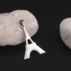 Polished stainless steel Eiffel Tower pendant necklace charm on white stone base