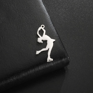 Polished silver figure skater pendant showing detailed silhouette on black leather texture