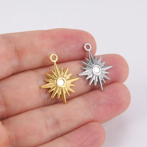 18K gold and silver sun star pendants held in hand for DIY jewelry making size reference