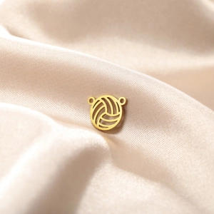 Golden volleyball pendant with hollow lines on champagne satin for DIY jewelry