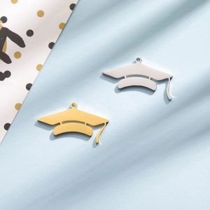Detailed view of silver and gold graduation cap pendants for DIY jewelry and gifts