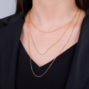 Elegant gold layered triple strand necklace with fine link chains on female model