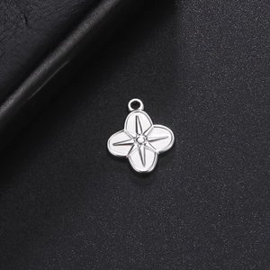Modern stainless steel four-leaf clover pendant with starburst relief on black background