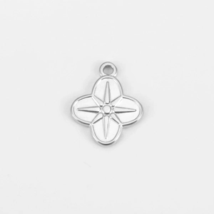 Macro shot of silver stainless steel four-leaf clover pendant with star pattern