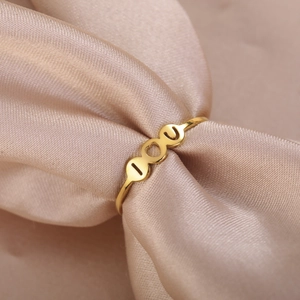 Elegant gold I Love You heart open ring displayed on premium champagne silk fabric