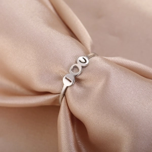 Elegant I Love You heart ring in silver finish on champagne silk backdrop