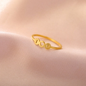 Gold stainless steel I Love You ring with heart on elegant pink silk background