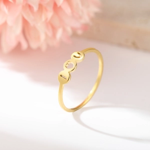 Macro shot of gold stainless steel ring featuring 100 digits and a heart-shaped hollow design