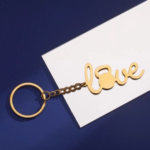 Close-up of golden kettlebell Love keychain with a polished metal finish and sturdy ring