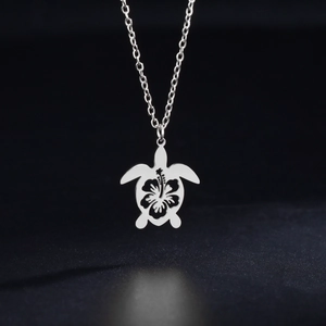 Polished stainless steel sea turtle pendant necklace with hollow hibiscus flower design