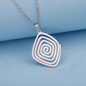 Minimalist silver spiral pendant necklace with cross chain on a blue display stand