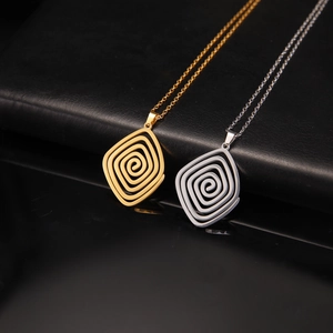 Minimalist geometric spiral pendant necklace in gold and silver finish on black background