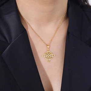 Gold stainless steel necklace with hollow Celtic knot and cross pendant on black suit