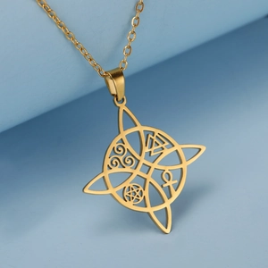 Macro shot of gold Celtic knot pendant with mystical symbols on a light blue platform