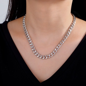 Men's silver cuban chain necklace in polished stainless steel worn on a model
