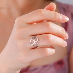 Elegant cutout cat paw stainless steel ring worn on a finger for a minimalist fashion look