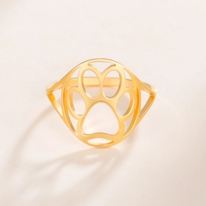 Close-up of golden stainless steel ring featuring a minimalist cutout cat paw design