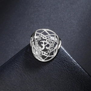 Detail of silver stainless steel Om lotus ring with intricate mandala cut-out patterns