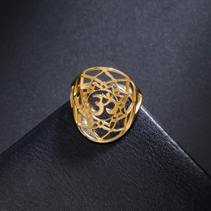 Elegant 18K gold plated hollow yoga Om symbol ring on a black leather texture display