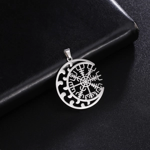 Viking Vegvisir compass and crescent moon silver pendant on black leather background