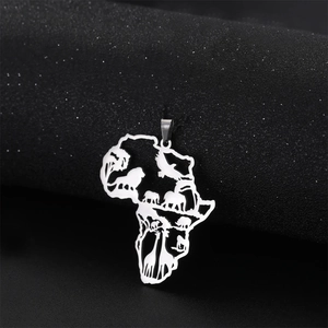 Macro shot of silver hollow-out Africa map pendant with elephant and giraffe details