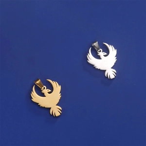 Macro shot of eagle pendant pendants in polished gold and silver finishes