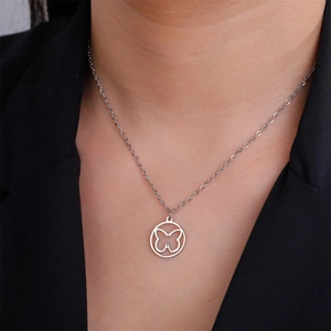 Detailed close-up of a hollow butterfly circle pendant necklace on a polished chain