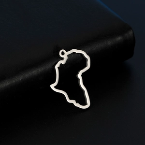Polished silver hollow Africa map pendant necklace accessory on black leather background