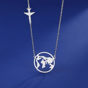 Polished silver world map pendant necklace with airplane charm on blue background