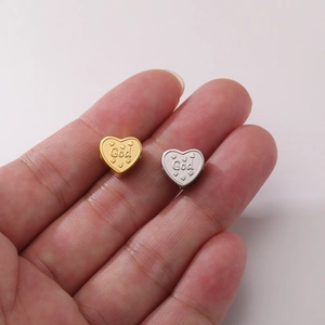 18K gold-plated heart-shaped bead with God engraving shown on a finger for size