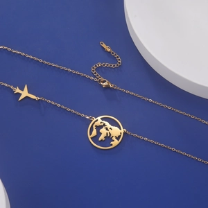 Detail view of gold stainless steel world map and airplane pendant travel necklace