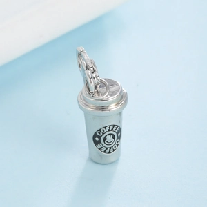 Silver coffee cup pendant with smiley face logo and lobster clasp on light blue background