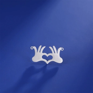 Close-up of heart-shaped hands pendant in silver steel with dual loops for DIY jewelry