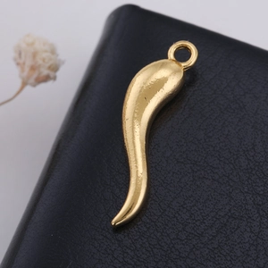 Detailed close-up of a gold-plated chili pepper charm pendant on black leather texture