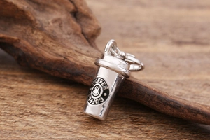 Macro view of coffee cup pendant in antique silver finish with lobster clasp detail