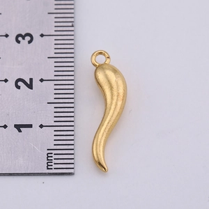 Detailed view of a 25mm matte gold chili pepper charm with ruler for size reference