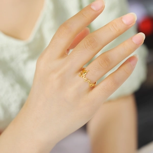 Minimalist gold heartbeat wave stainless steel ring worn on index finger for women