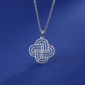 Silver stainless steel Celtic knot pendant necklace on a solid blue background