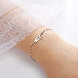 Elegant stainless steel chain bracelet with a gothic letter pendant on a female wrist